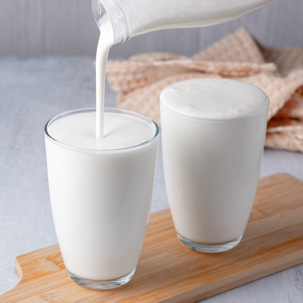 Two Glasses of Buttermilk on a Clear 
Glass