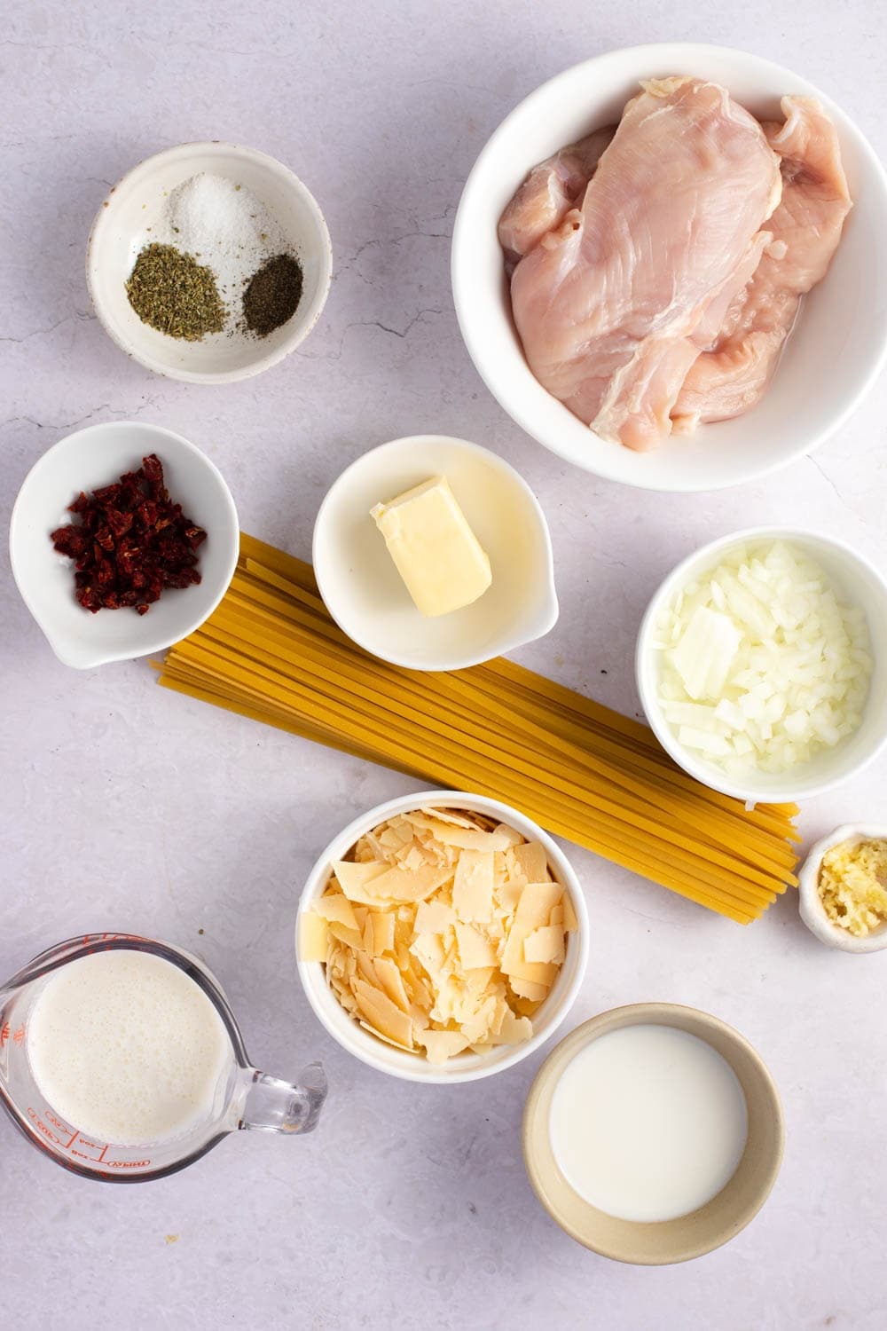 Chicken Florentine Pasta Ingredients - Pasta, Chicken, Seasoning, Butter, Onion, Sun-Dried Tomatoes, Garlic, Heavy Cream, Milk and Spinach