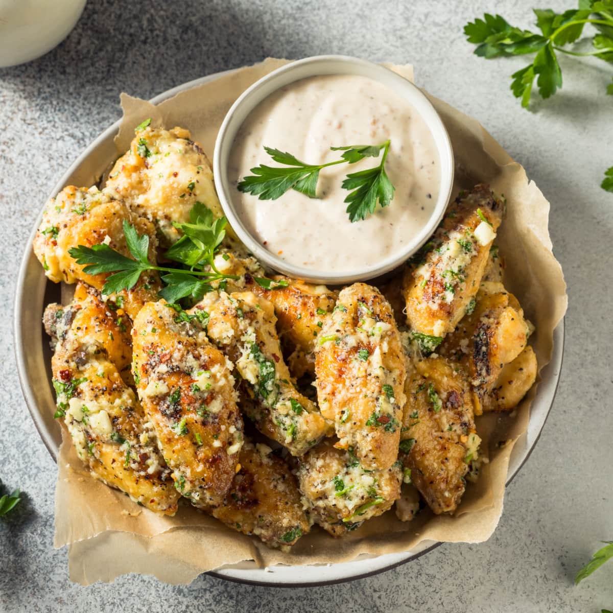 Appetizing Garlic Parmesan Sauce Flavored Chicken Wings Served on a  Bowl