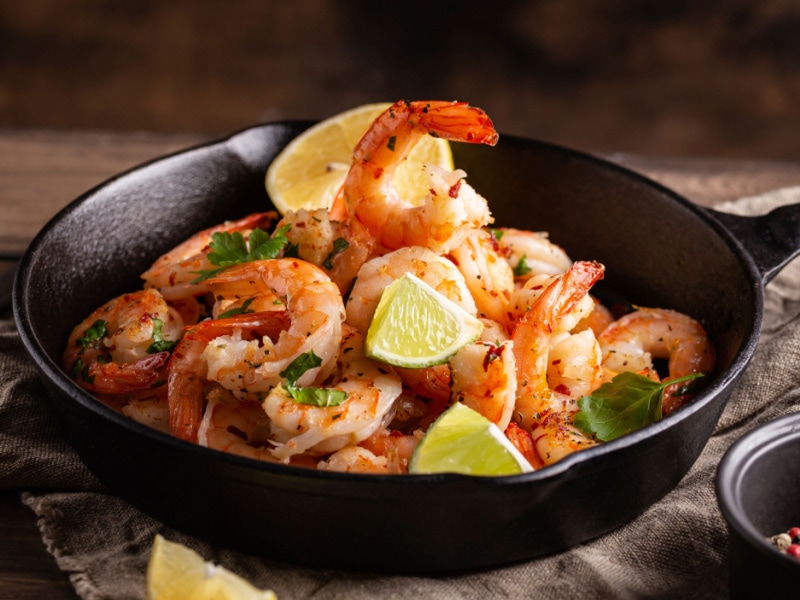 Grilled Shrimps Seasoned With Lemon, Greens and Herbs in a Pan