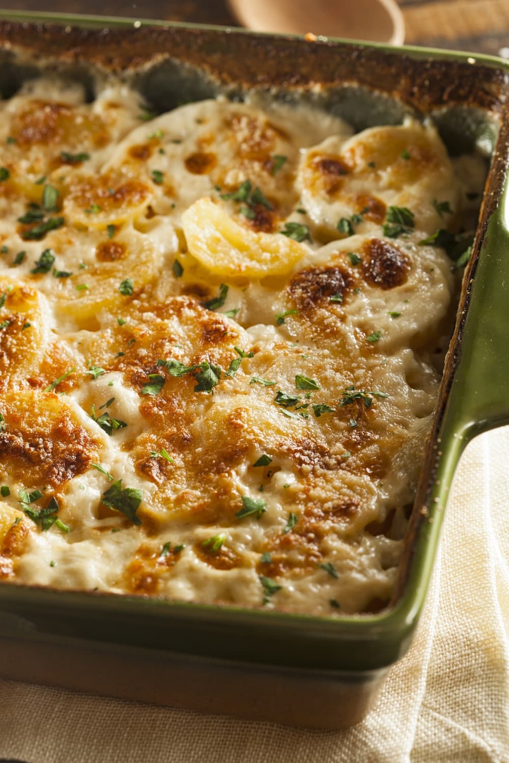 Homemade Scalloped Potatoes in a Green Casserole