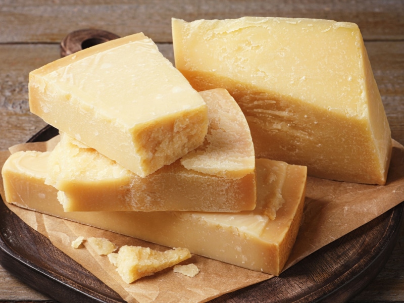 Large Chunks of Parmesan Cheese on a Wooden Platter