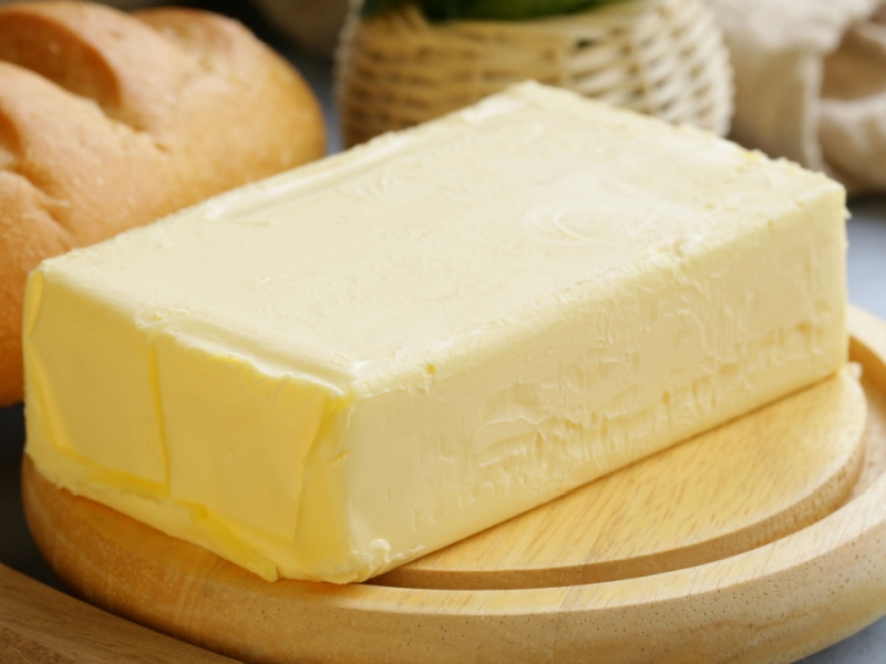 Block of Butter on a Wooden Cutting Board