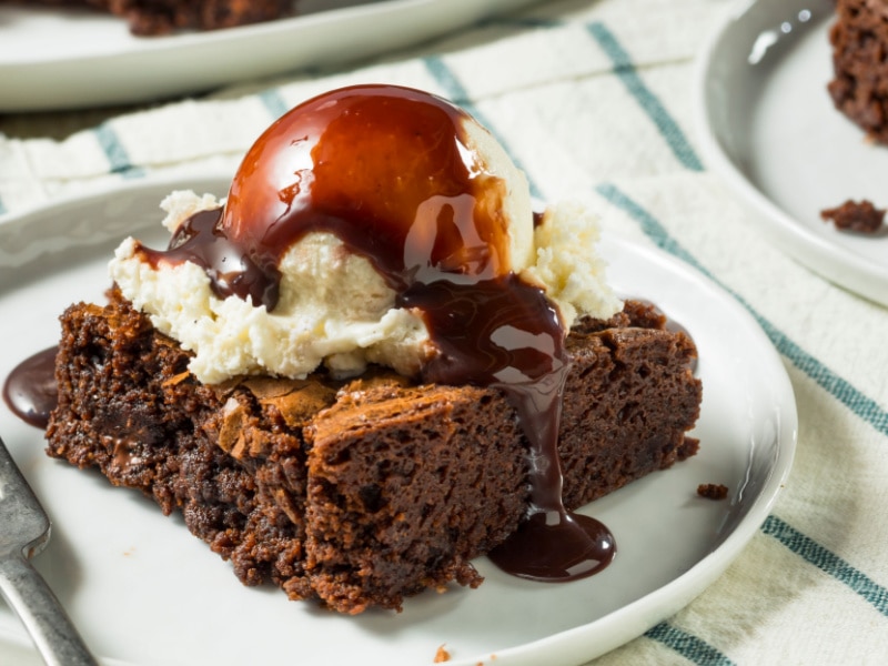 Brownie Topped with Ice Cream and Chocolate Syrup