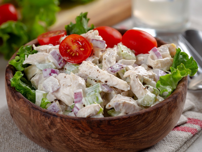 Chicken Salad on a Wooden Bowl Garnished With Ripe Tomato Cherries