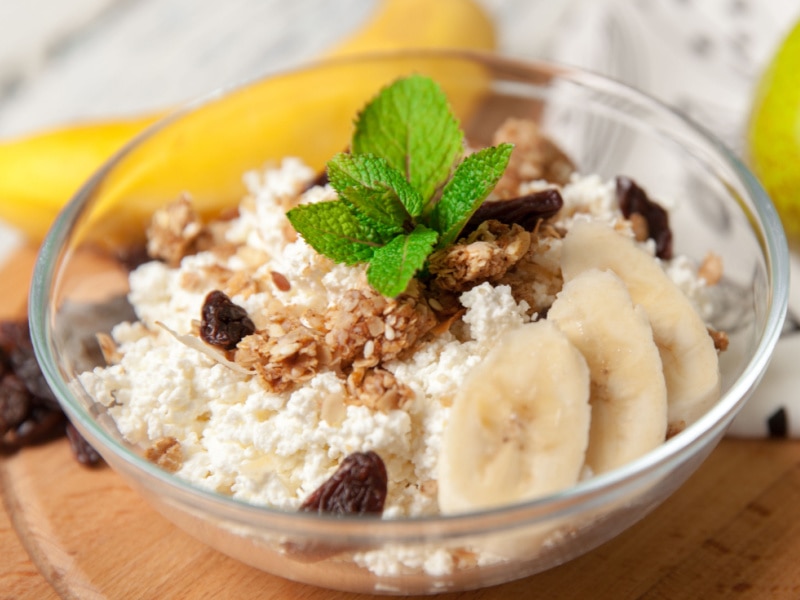 Cottage cheese with slices of banana, nuts and grapes.