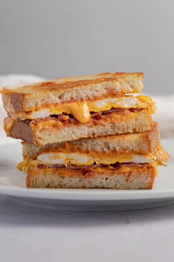 Fried egg sandwich stacked on a plate