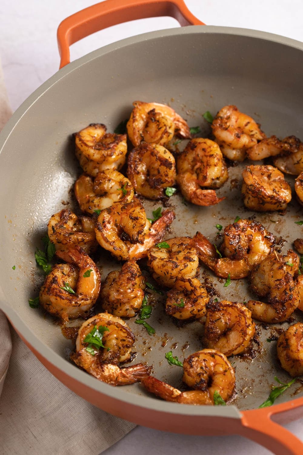 Shrimp with Cajun seasoning on pan. 