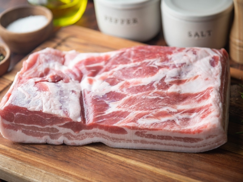 Fresh Pork belly Block on a Chopping Board