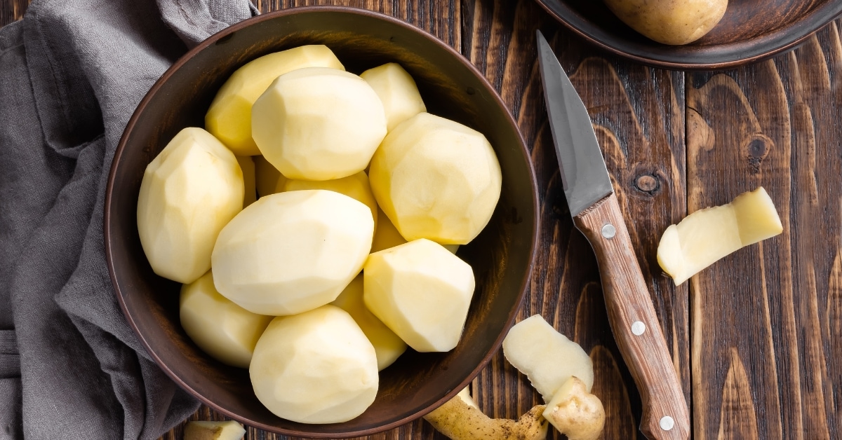 Raw Fresh Potatoes on a Wooden Bowl