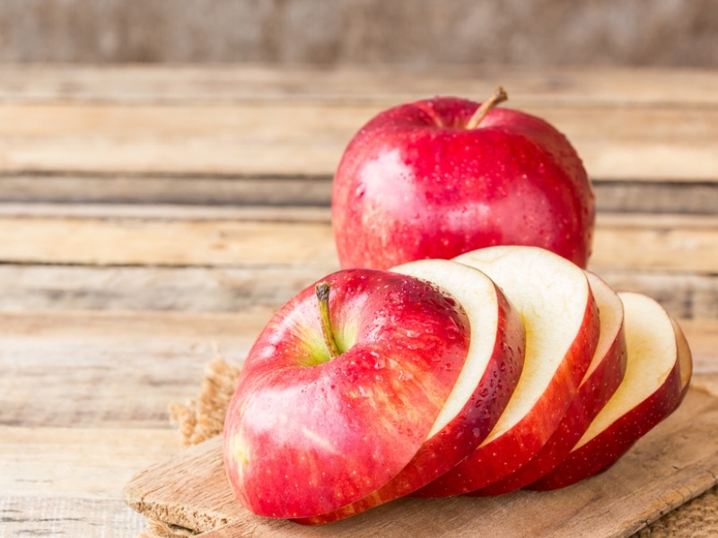 Sliced Red Apples on a wooden table