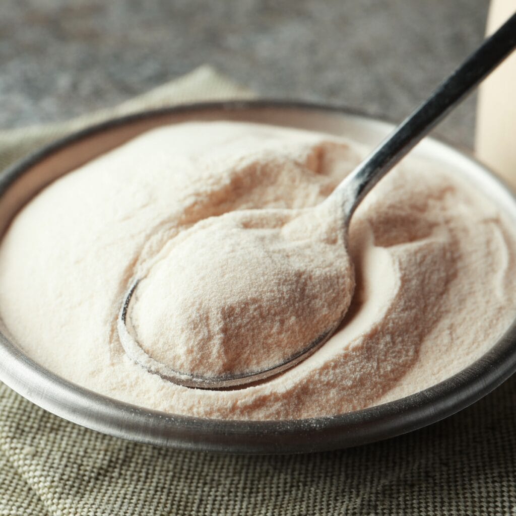 Bowl of Agar Powder with a Spoon Dipping Into Agar Powder