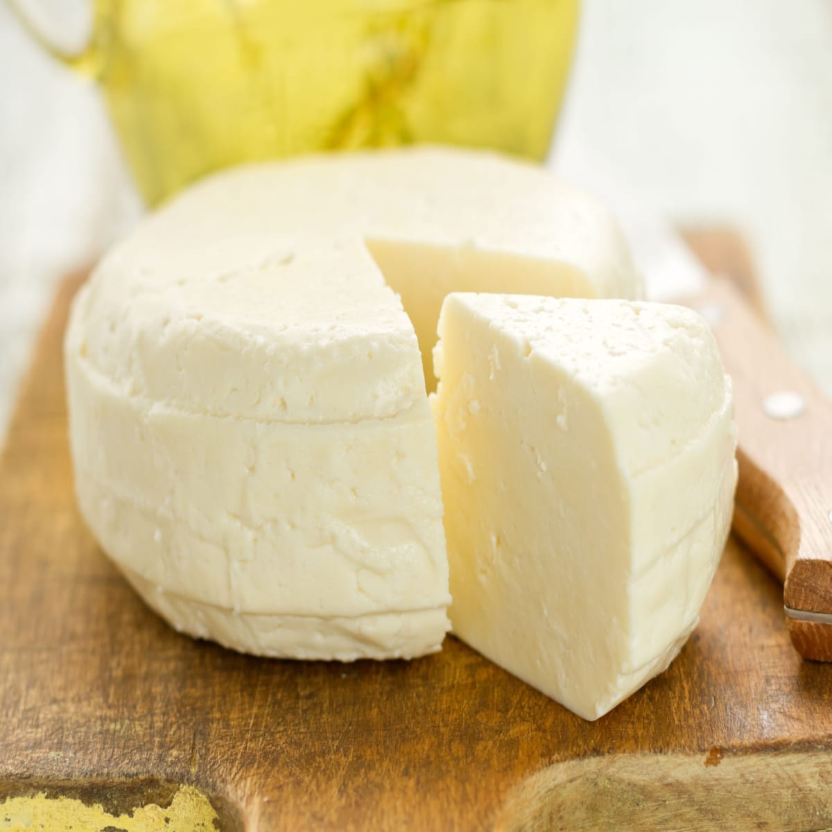 Block of Asadero Cheese on a Wooden Cutting Board