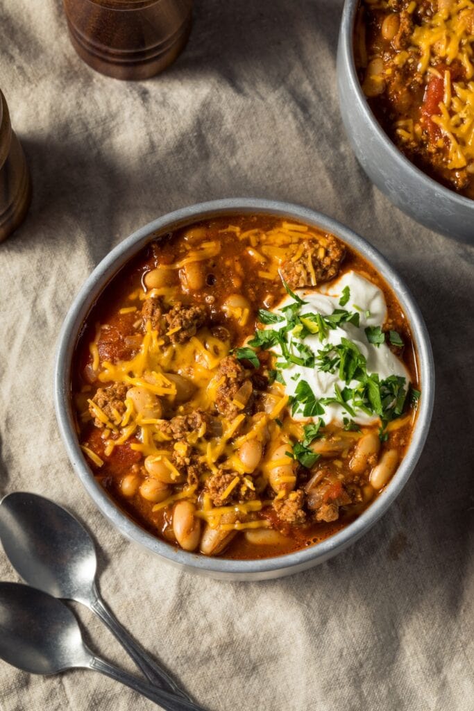 Bowl of Ground Turkey Chili with Sour Cream and Cheese