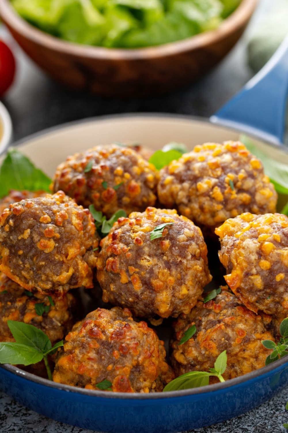 Cheesy sausage balls in a blue bowl. 