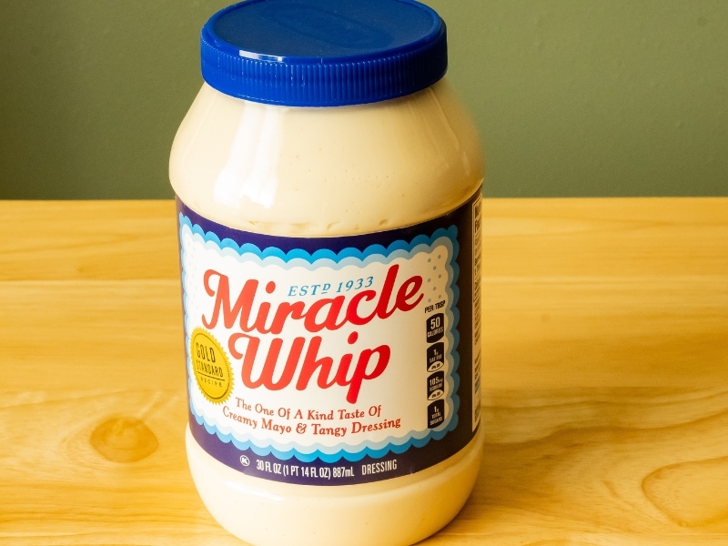 A Plastic Jar of Miracle Whip on a Wooden Table