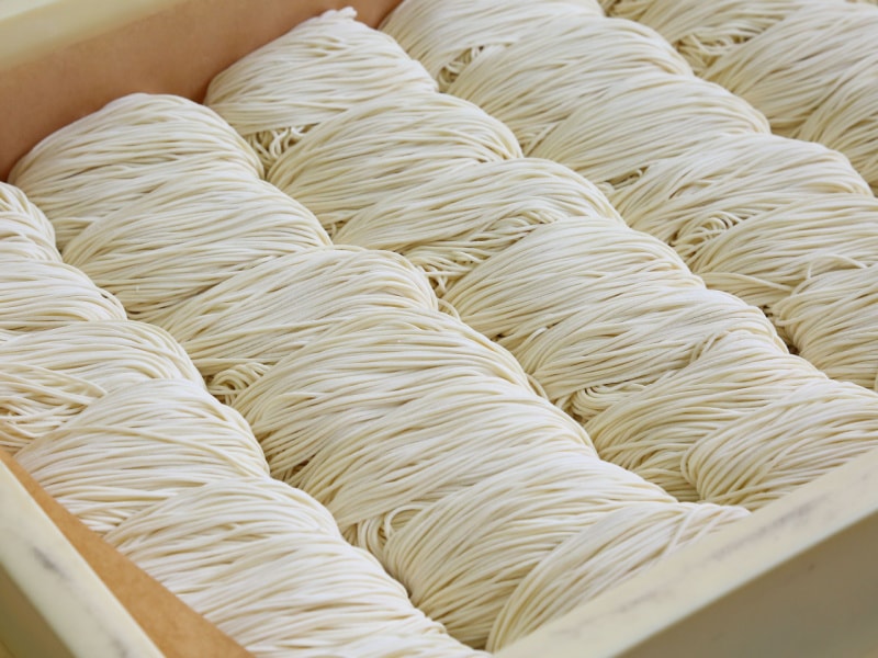 Raw Uncooked Ramen Noodles in a Wooden Box