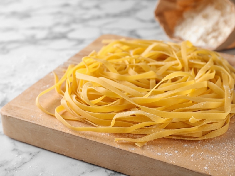 Dried Egg Noodles on a Wooden Board 