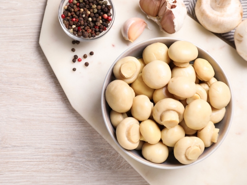 Spices and Raw Button Mushrooms in a Bowl