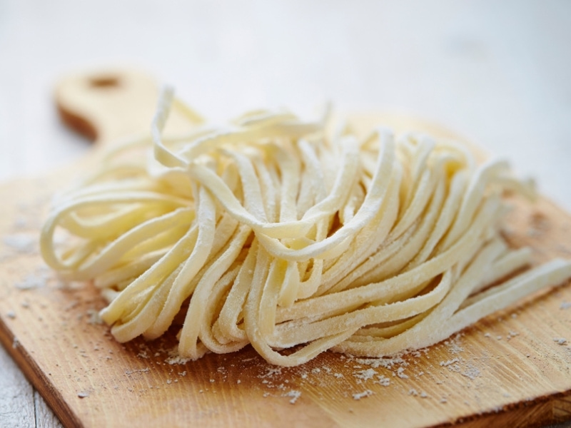 Raw Homemade Udon Noodles on a Wooden Chopping Board