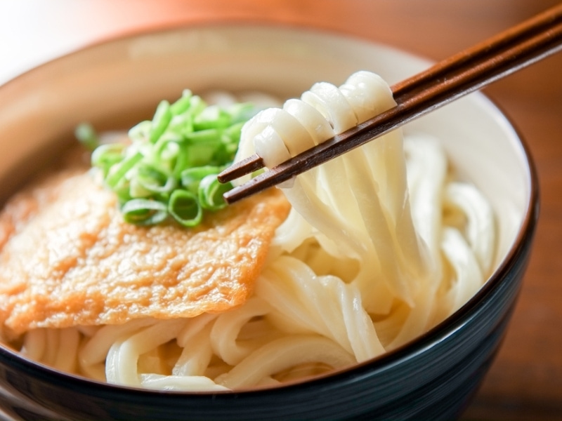 Udon Noodles Soup, Garnished With Fish Cake and Fresh Chopped Leaks
