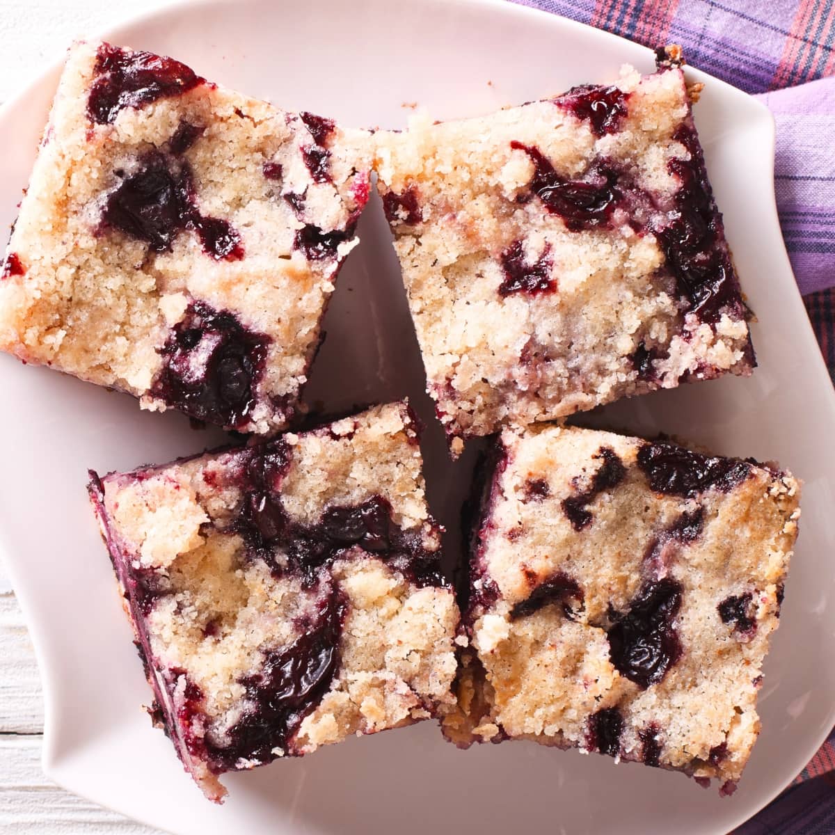 Top down view of sliced blueberry coffee cake on a plate