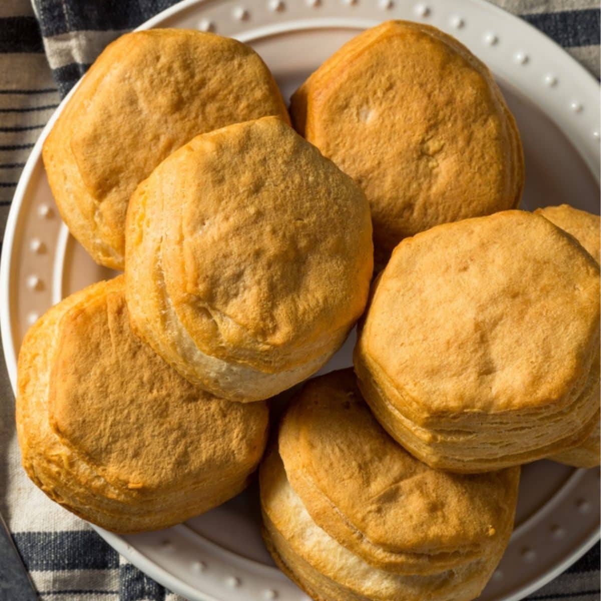 Top view of round honey biscuits served on a white plate