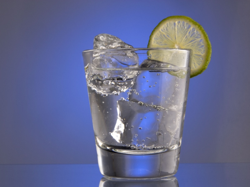 A Glass of Club Soda with Ice and Garnished with Lime