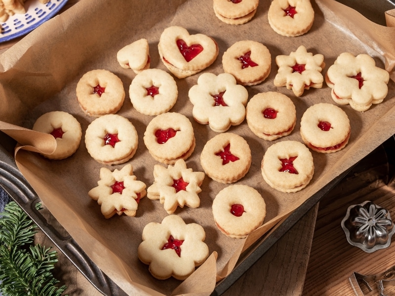 Homemade Linzer Cookies on a Baking Sheet With Lined With Parchment Paper