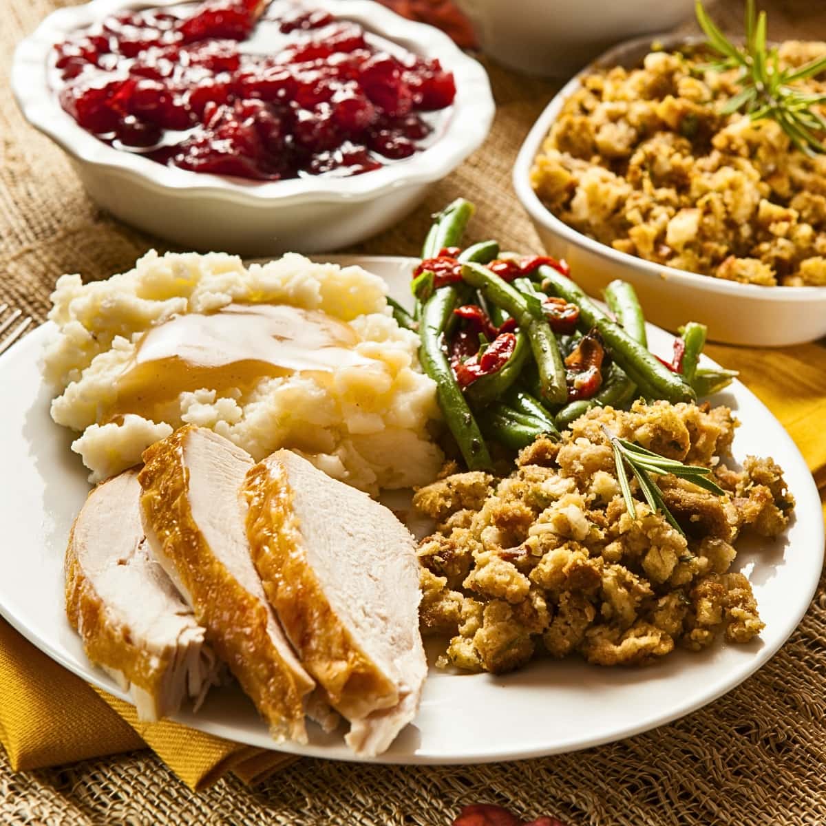 Cornbread Dressing Served With Green Beans, Sliced Pork and Mashed Potatoes