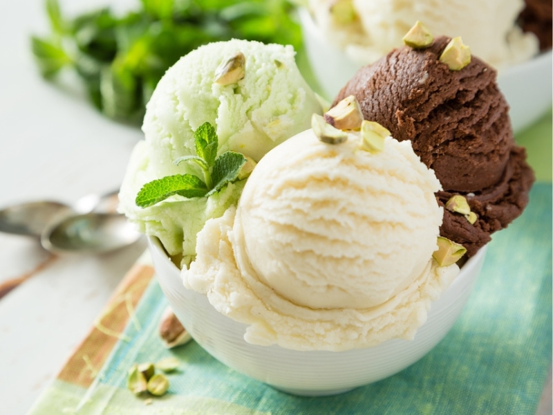 Bowl of Scoop of Pistachio, Vanilla and Chocolate Ice Cream Garnished with Pistachios and a Sprig of Mint