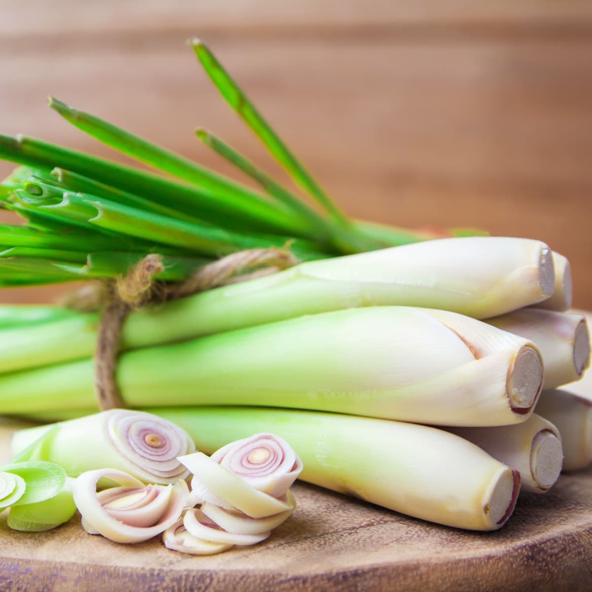 Tied Lemon Grass Slice on Half on a Wooden Cutting Board