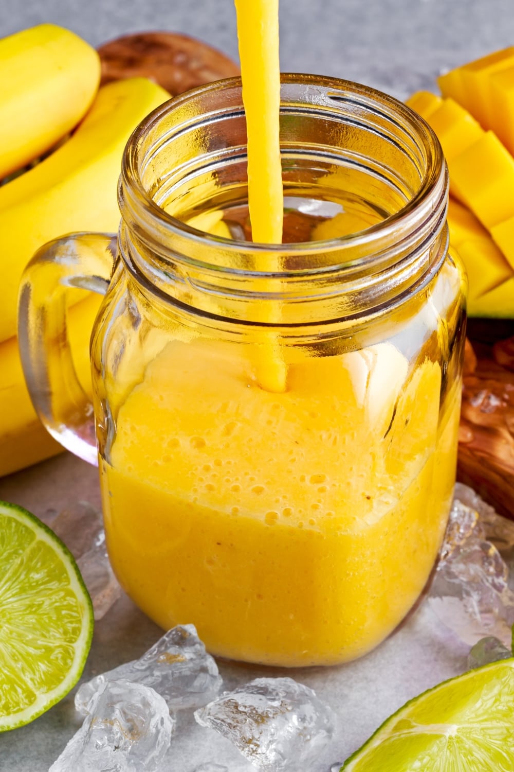 Mango Smoothie Poured on a Mason Jar