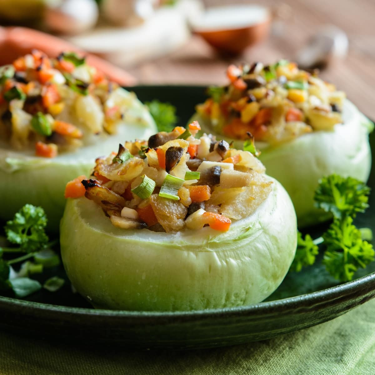 Roasted Kohlrabi Dish Stuffed with Various Roasted Veggies on a Large Black Serving Platter