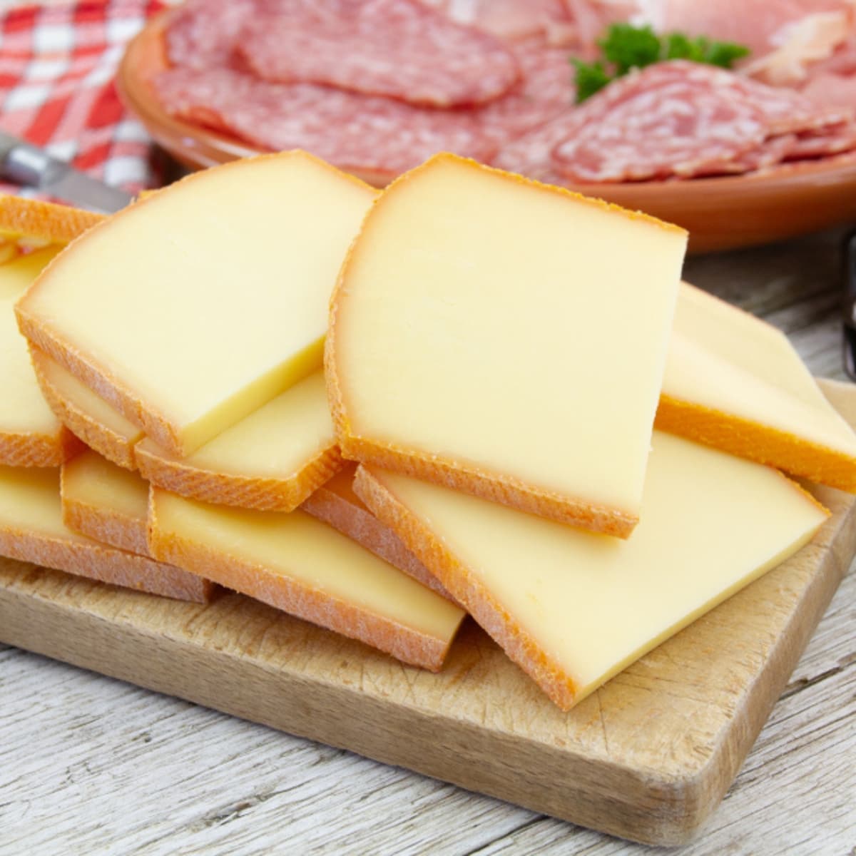 Sliced Cheese on a Wooden Board 