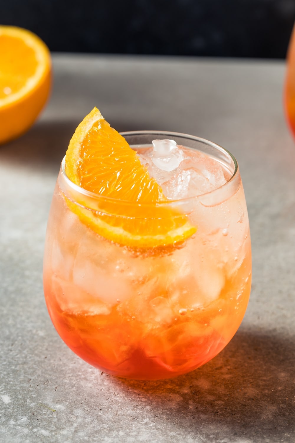 Glass of Refreshing Boozy Aperol Spritz Garnished With a Slice of Orange