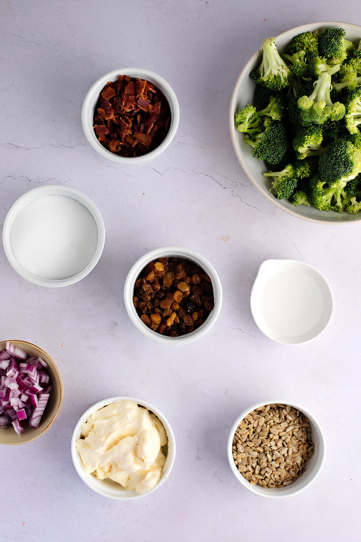 Bowl of Fresh Broccoli, Onions, Bacon and Other Ingredients Laid on the Table