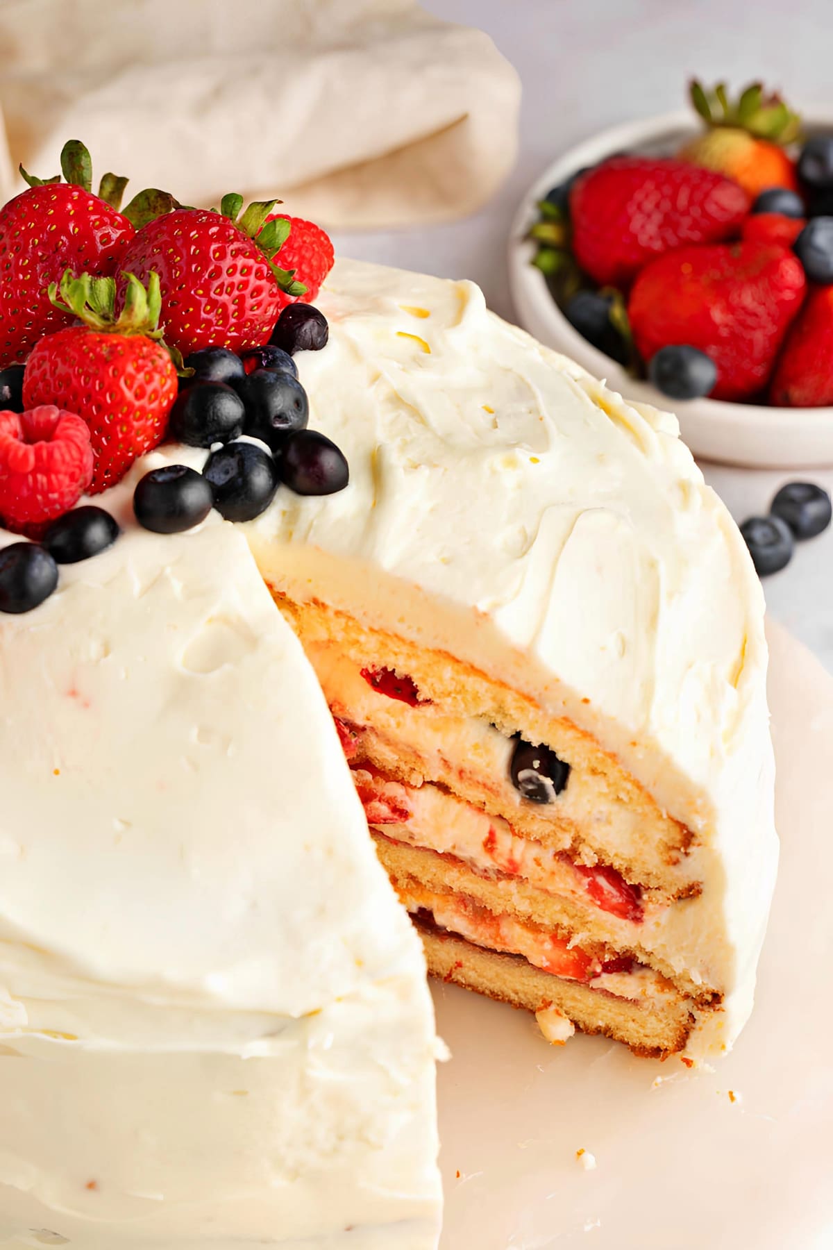 Chantilly Cake Slice and Fresh Strawberries and Blueberries