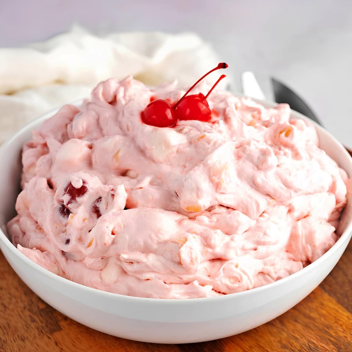 Bowl of Cherry Fluff with Maraschino Cherries on Top