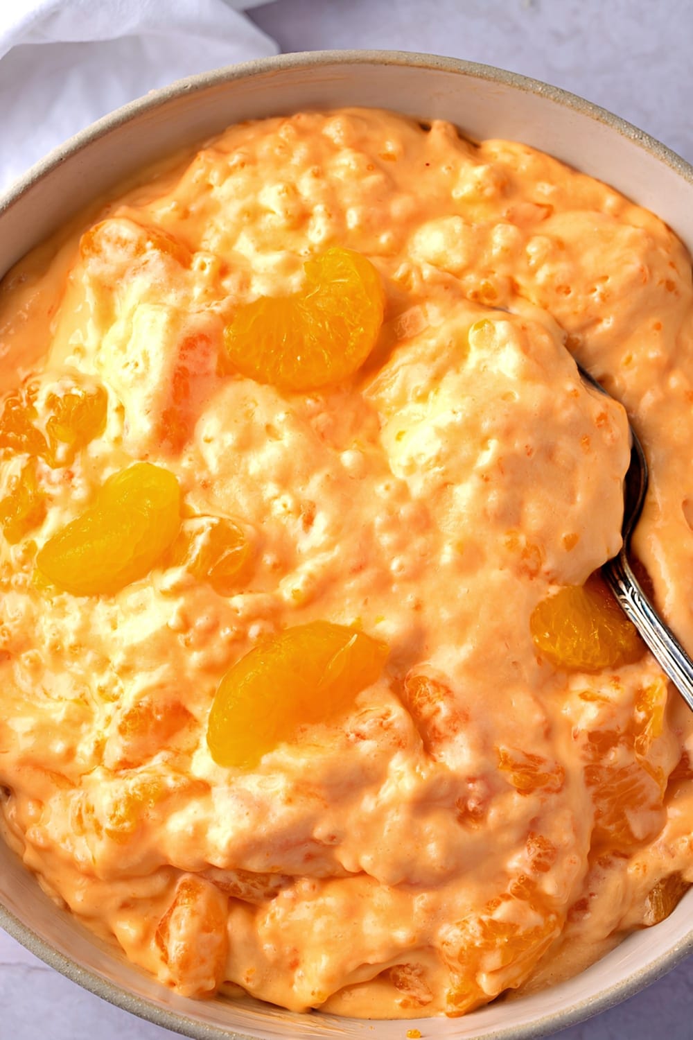 Spoon Scooping Creamy Orange Creamsicle Salad From a Bowl