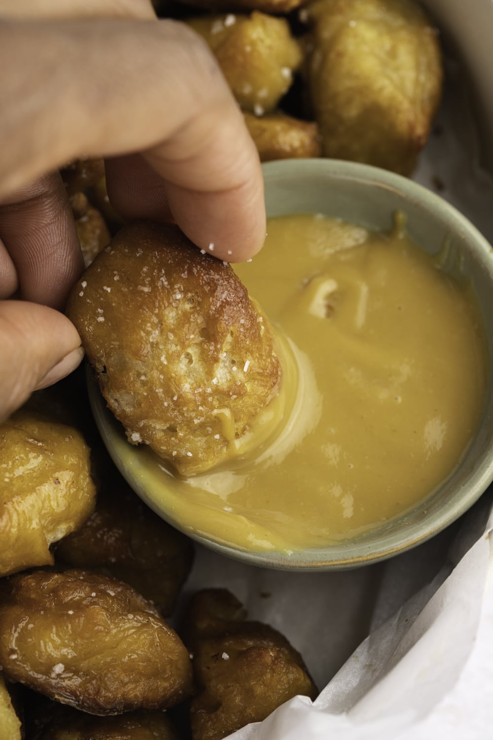 Soft pretzel bites dipped in a buttery sauce.