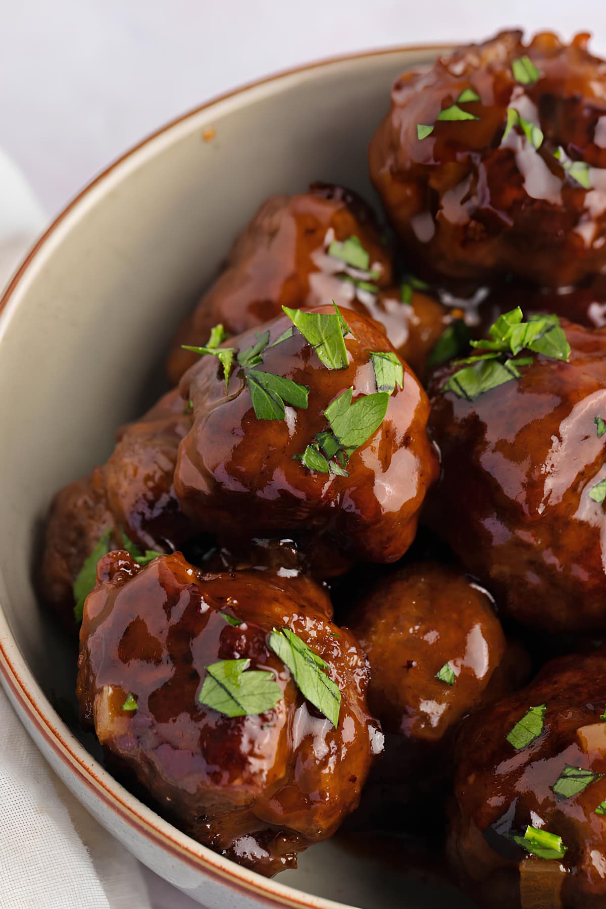 Sweet and Sour Meatballs in a Bowl with Parsley