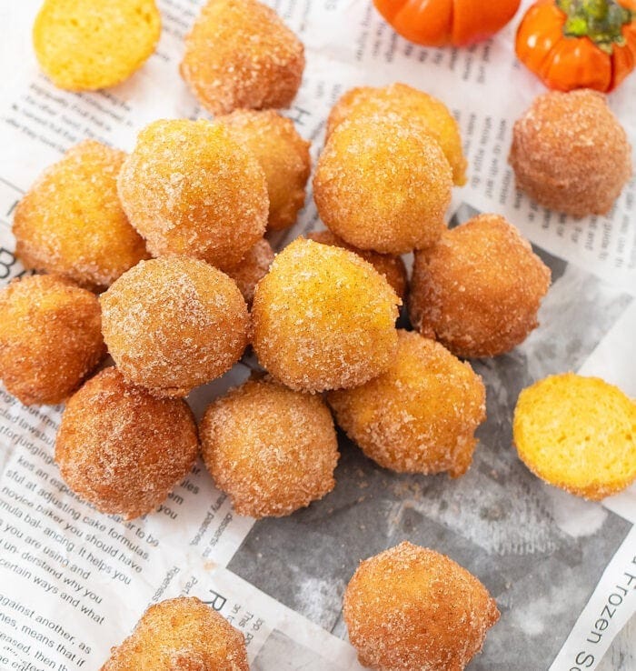 Bunch of two ingredient pumpkin donuts covered with sugar. 