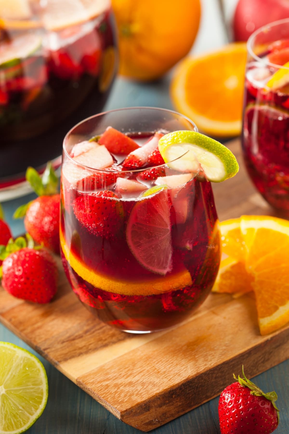 A Glass of Cold Red Sangria with Strawberries, Orange and Lime