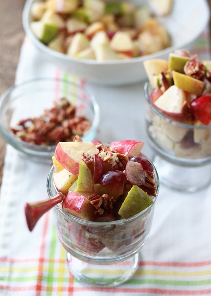 Autumn fruit salad with apples, pears, and grapes are drizzled with a creamy cinnamon dressing. 