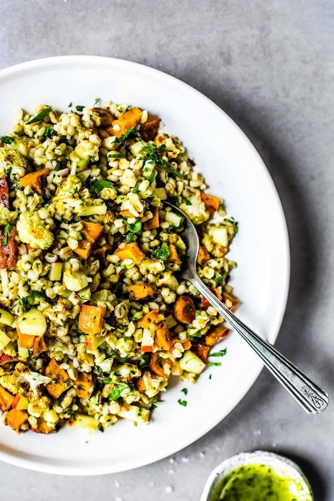 Autumn glow salad with mix of sweet potato, crispy apple, roasted cauliflower, fresh parsley, and freekeh grains. 