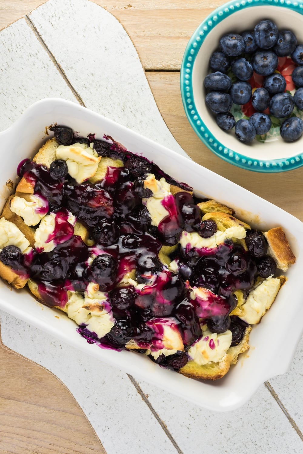 Top view of blueberry French toast in a white casserole dish. 