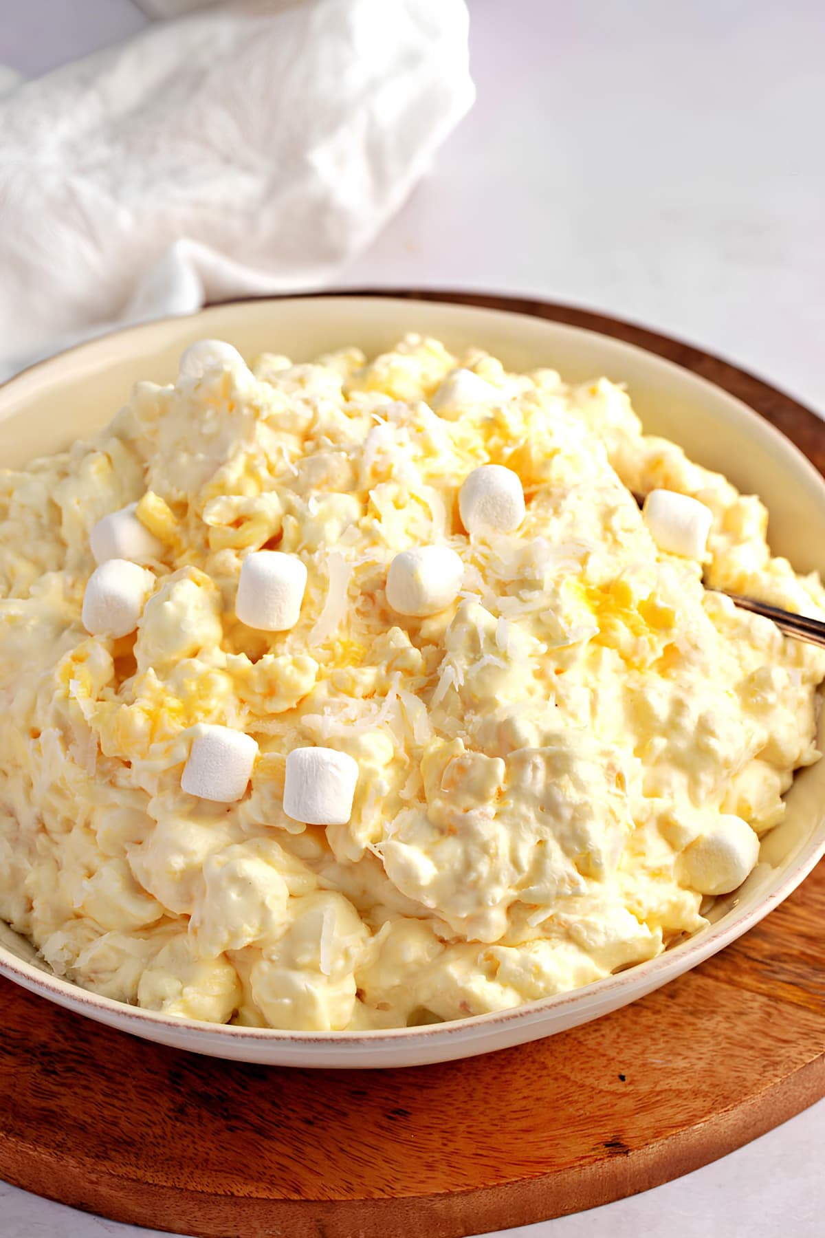 Bowl of Homemade Pineapple Fluff with Shredded Coconuts and Mini-Marshmallows