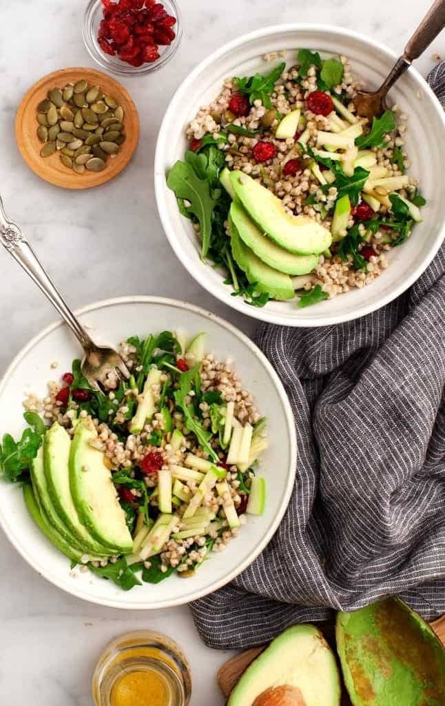 Bowls of Buckwheat, Apple, Cranberry Avocado Salad with fresh lemons, maple syrup, and Dijon