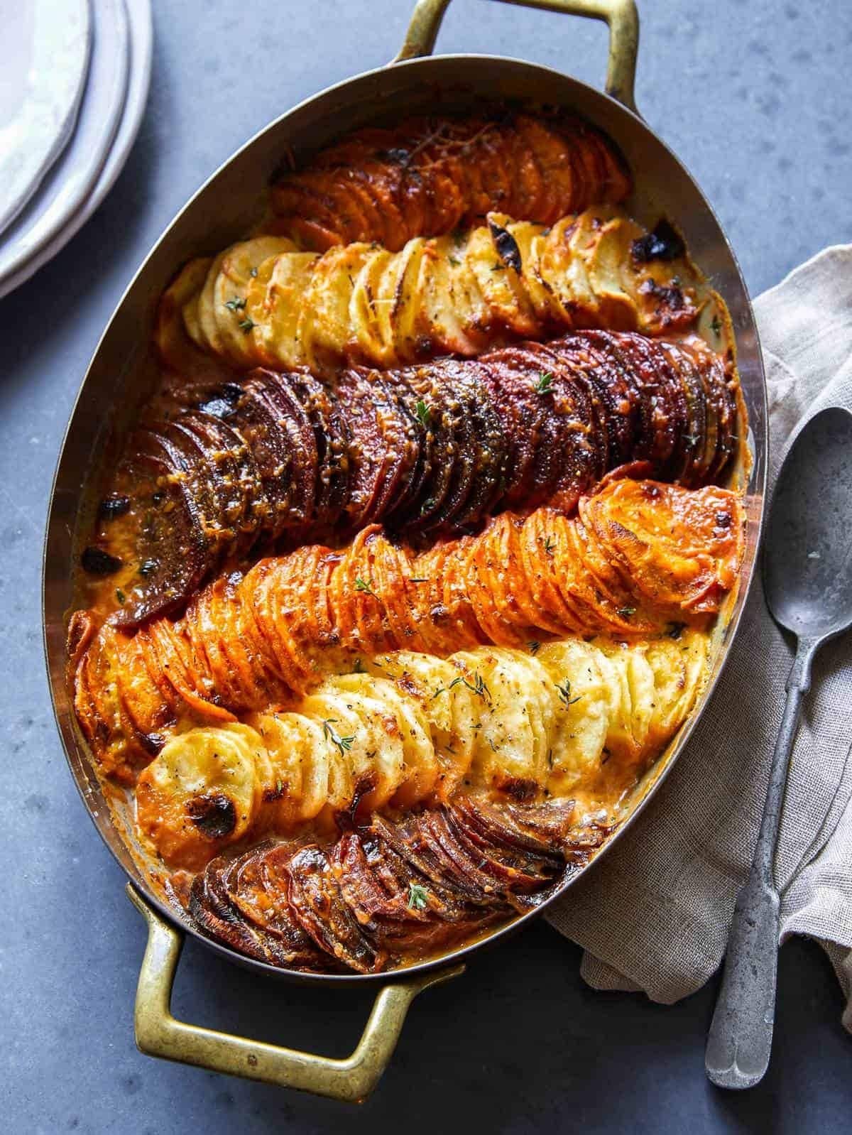 Cheesy root vegetable gratin made with beets, parsnips, and potatoes, plus cream and garlic.  